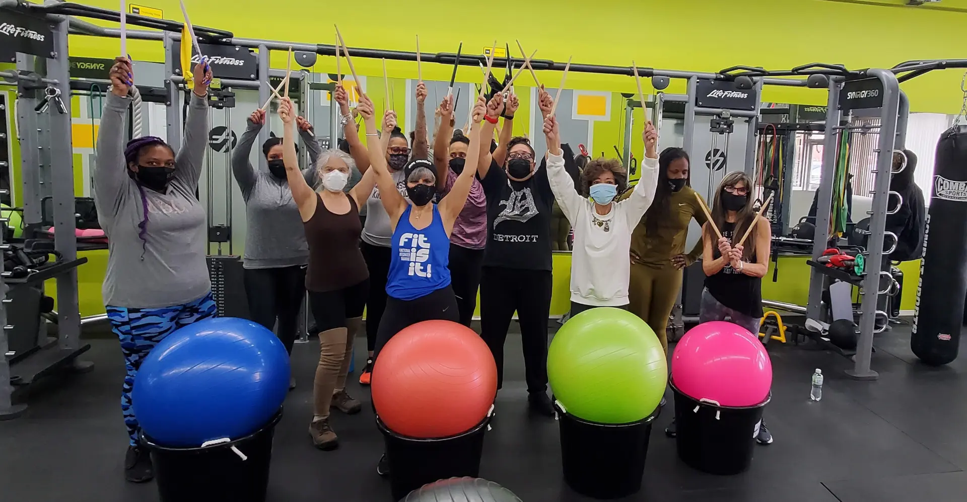 A group of people standing in front of some colorful balls.